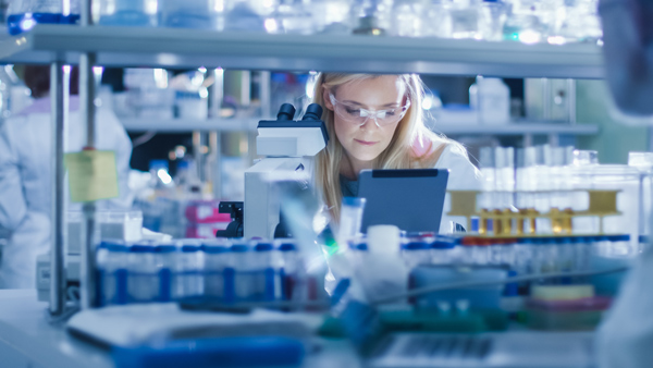 blonde scientist working in lab on iPad